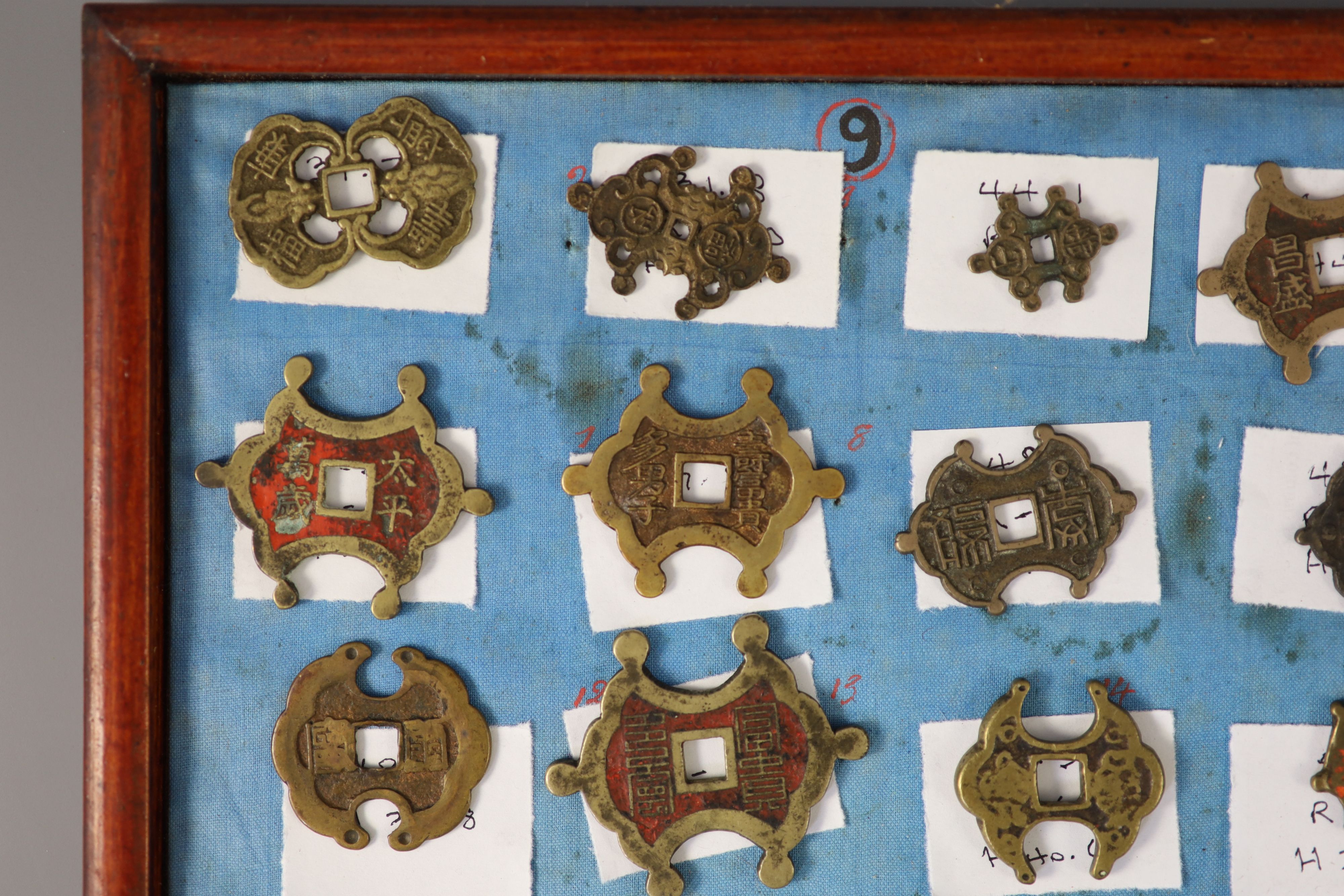 A group of 99 Korean bronze and metal amulets or charms, 19th/20th century
